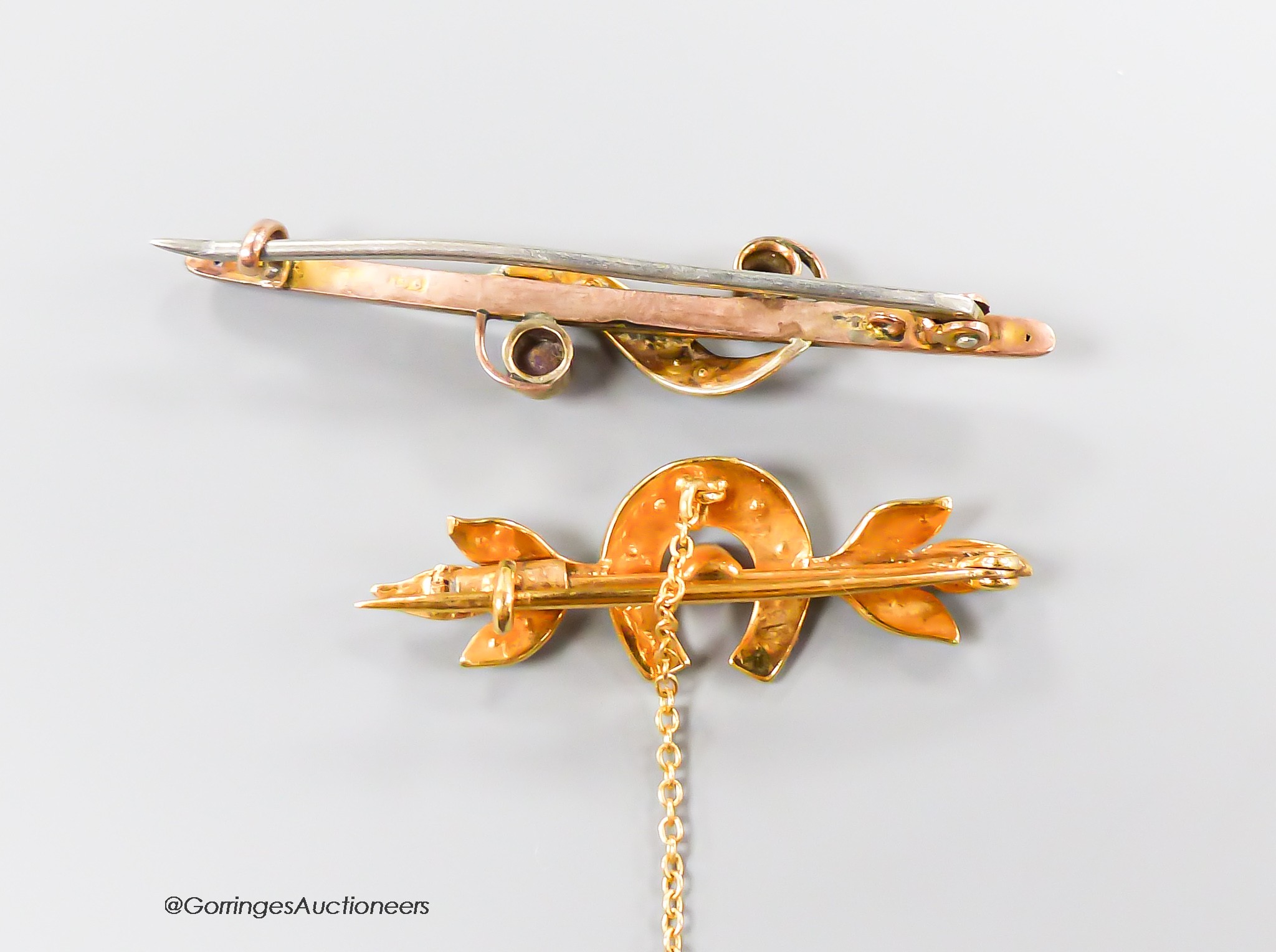 Two early 20th century yellow metal bar brooches including seed pearl set horseshoe, 34mm, gross 4.7 grams.